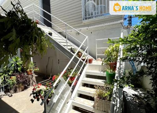 a house with stairs with potted plants on it at ARNAS HOME in San Andrés