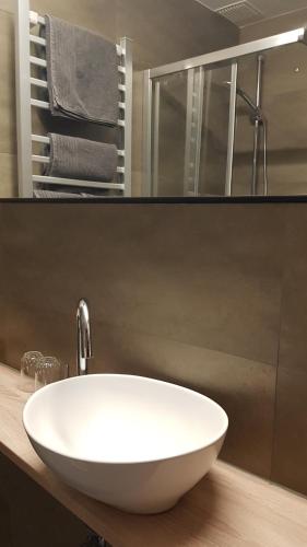 a bathroom with a white sink and a mirror at Hotel Landgasthof Hirsch in Marktlustenau