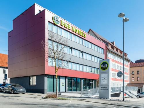 a building with a sign on the side of it at B&B HOTEL Albstadt-Hbf in Albstadt