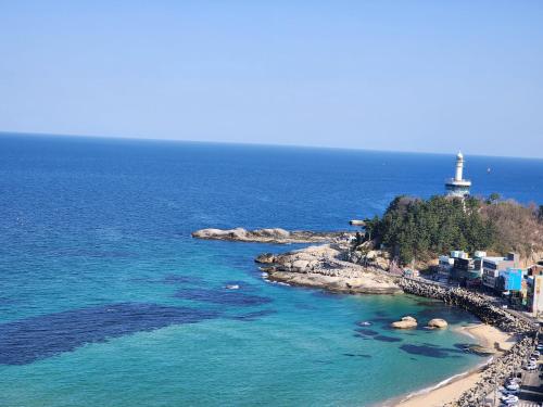 an aerial view of a beach with a lighthouse at Sokcho Summitbay 1807 "Ocean View" in Sokcho