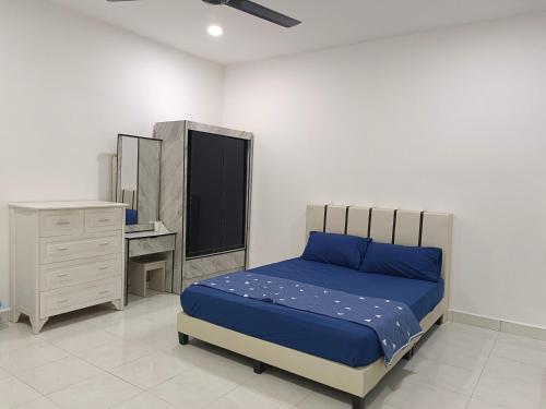 a bedroom with a bed and a dresser and a desk at 8Pax comfortable setia residen in Sitiawan