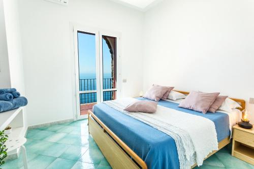 a bedroom with a bed with a view of the ocean at Villa Venere - Amalfi Coast in Cetara