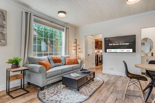 a living room with a couch and a table at Del Norte Cottage - Downtown King BBQ Fire Pit in Colorado Springs