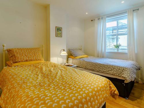 a bedroom with two beds and a window at 2 bed in Tenby 88738 in Tenby