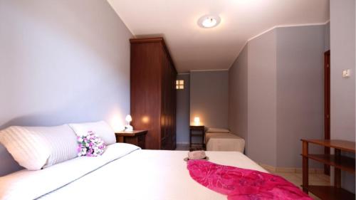 Ένα ή περισσότερα κρεβάτια σε δωμάτιο στο Ficus Plus - Pineto Vacanza