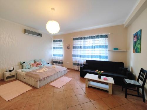 a living room with a bed and a couch at Jackpot Apartman in Budapest