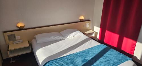Ένα ή περισσότερα κρεβάτια σε δωμάτιο στο Brit Hotel Confort Gien