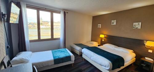 Ένα ή περισσότερα κρεβάτια σε δωμάτιο στο Brit Hotel Confort Gien