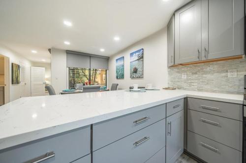 a kitchen with white cabinets and a white counter top at Wailea Ekahi 24B in Wailea
