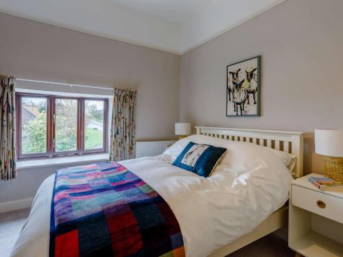 a bedroom with a large bed and a window at 2 Bed in Wedmore 82378 in Theale