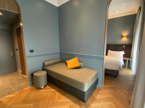 a small room with a bed and a mirror at Hotel Berna in Milan