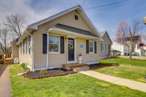 a small yellow house with a porch at Spacious North East Home with Fenced Yard and Fire Pit in North East