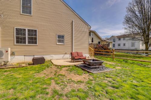 a backyard with a fire pit and a house at Spacious North East Home with Fenced Yard and Fire Pit in North East