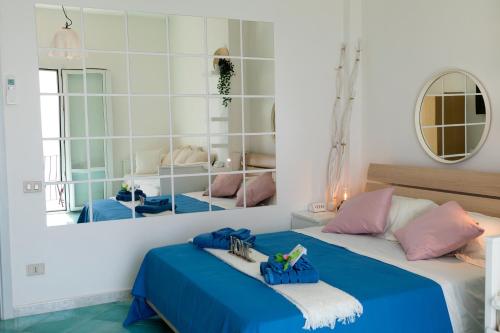 a bedroom with two beds and a mirror at Villa Venere - Amalfi Coast - Private Sea Access in Cetara