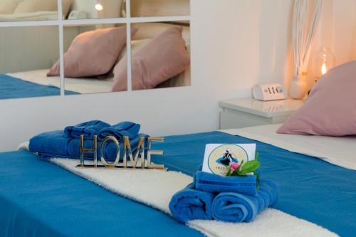 a bedroom with a blue bed with a home sign on it at Villa Venere - Amalfi Coast - Private Sea Access in Cetara