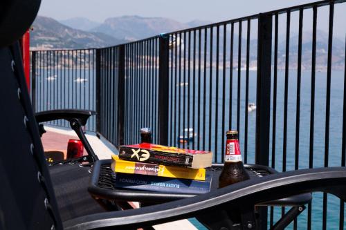 a table with two bottles of beer and a book at Villa Venere - Amalfi Coast - Private Sea Access in Cetara