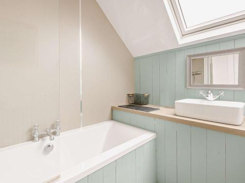 a bathroom with a white sink and a mirror at 3 Bed in Glen Clova 75284 in Kirriemuir