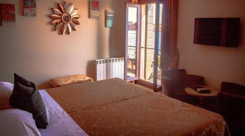 a bedroom with a bed and a large window at Hotel La Calcina in Venice