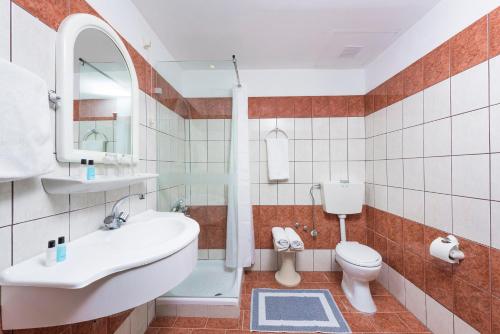 a bathroom with a sink and a toilet at Potamaki Beach Hotel in Benitses