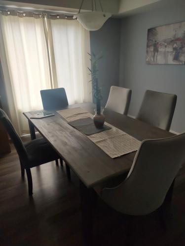 a dining room table with chairs and a plant on it at Double bed Suite - Very close to the Falls, Casinos and Marineland in Niagara Falls