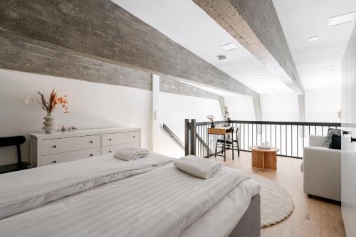 a bedroom with a large bed and a balcony at 2ndhomes Tampere "Pyynikki" Top Floor Loft Apartment in Tampere