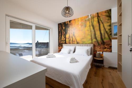una camera da letto con due letti e una grande finestra di 4 Seasons Rogoznica - Apartment a Rogoznica (Rogosnizza)