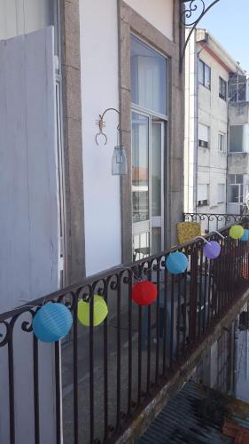 a group of colorful umbrellas on a balcony at Casa dragão in Porto