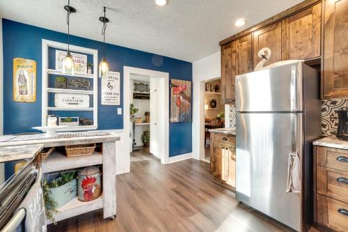 a kitchen with blue walls and a refrigerator at Walk to University Dtown Laramie Home! in Laramie