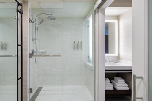 a bathroom with a shower and a sink at Renaissance Dallas Hotel in Dallas