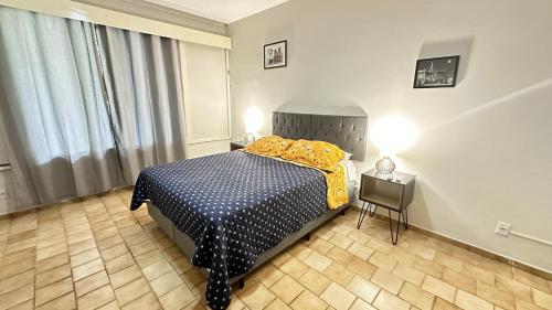 a bedroom with a bed and a table in it at Garden 437 Suítes in Florianópolis