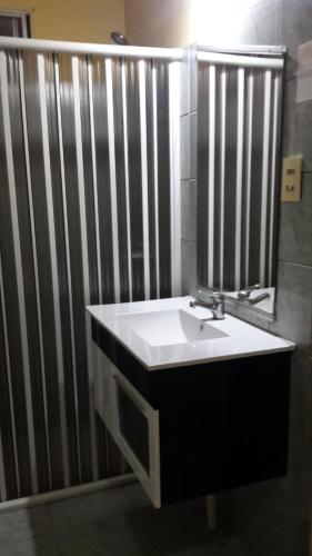 a bathroom with a sink and a mirror at Hotel A Mi Gente in Castillos
