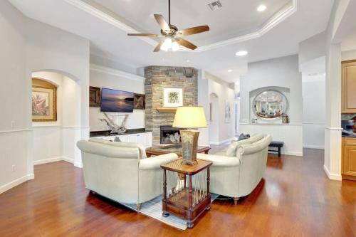a living room with two chairs and a table at Key West Vibes in Bonita Shores in Bonita Springs