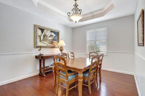 a dining room with a wooden table and chairs at Key West Vibes in Bonita Shores in Bonita Springs