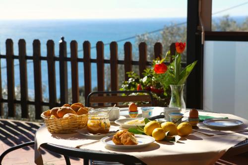 a table with bread and a basket of food on it at Hotel Rosita in Finale Ligure