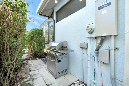 a grill outside of a building with a window at Key West Vibes in Bonita Shores in Bonita Springs