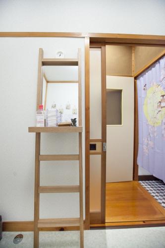 a room with a bunk bed with a ladder and a mirror at Stay Nikko Guesthouse in Nikko