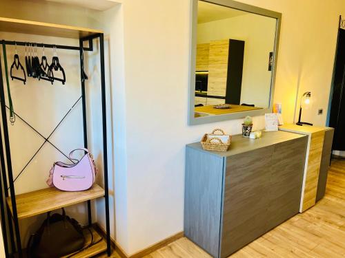 a dressing room with a mirror and a pink purse at Casa Tramonto e Poesia - Tamerò Estates in Montopoli in Sabina
