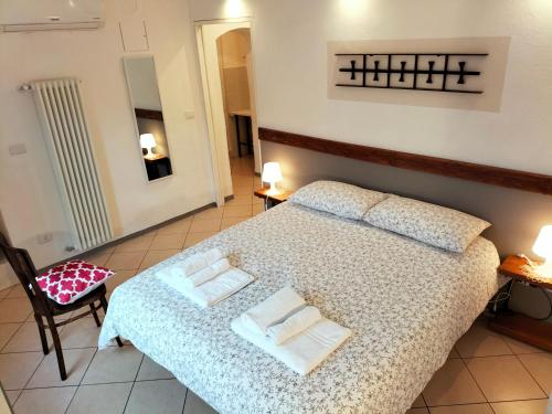 a bedroom with a bed with two pillows on it at Casa Laura in Magliano Alfieri