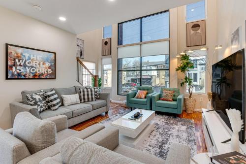 a living room with two couches and a table at Luxe Newark Retreat with Rooftop Deck Pets Welcome! in Newark
