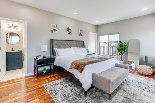 a bedroom with a large bed and a chair at Luxe Newark Retreat with Rooftop Deck Pets Welcome! in Newark