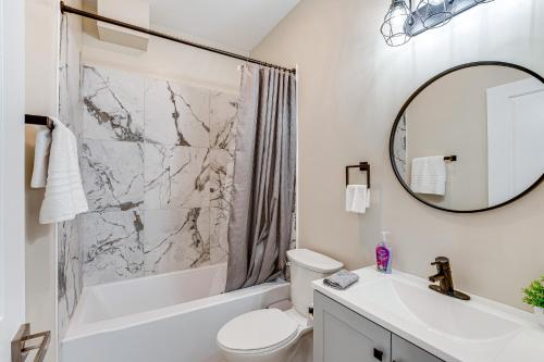 a bathroom with a sink toilet and a mirror at Luxe Newark Retreat with Rooftop Deck Pets Welcome! in Newark