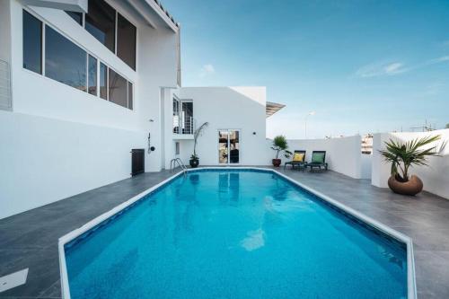 a swimming pool in the backyard of a house at Vakantievilla Jan Sofat, Curaçao in Willemstad