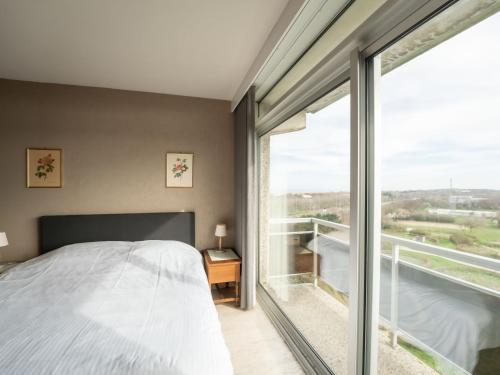 a bedroom with a bed and a large window at Apartment Residentie Astrid-1 by Interhome in Bredene