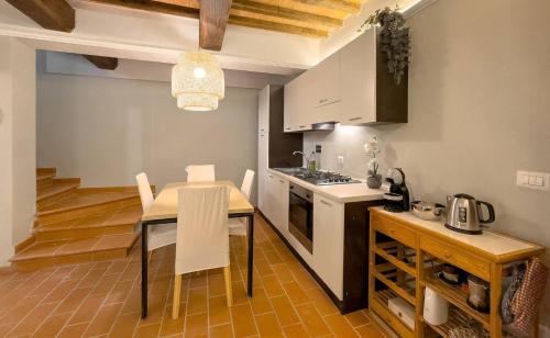 a kitchen and dining room with a table and chairs at Prestigious Home - Pool, Gazebo, and Stellar Views in Mazzolla