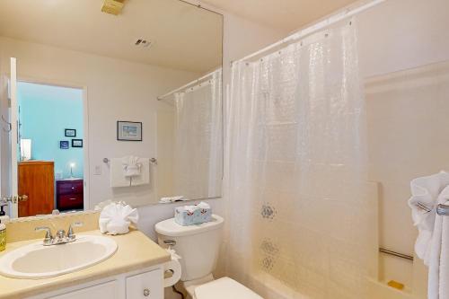 a bathroom with a toilet and a sink and a shower at Mountains & Palms #5648 in Palm Springs