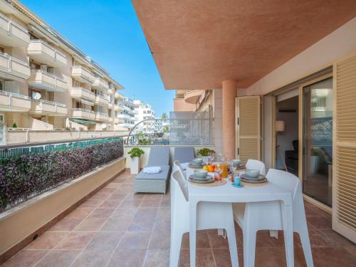 a white table and chairs on the balcony of a building at Apartment Maritimo by Interhome in Port d'Alcudia