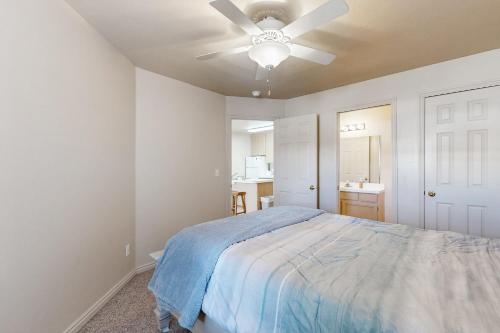 a bedroom with a bed and a ceiling fan at Harbor Village Pool Building Condo 104 in Garden City