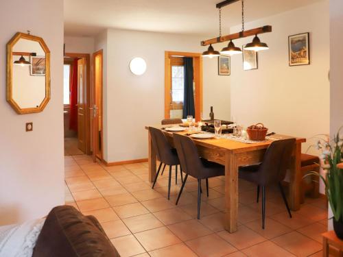 a dining room with a wooden table and chairs at Apartment Colline 1 by Interhome in Champex