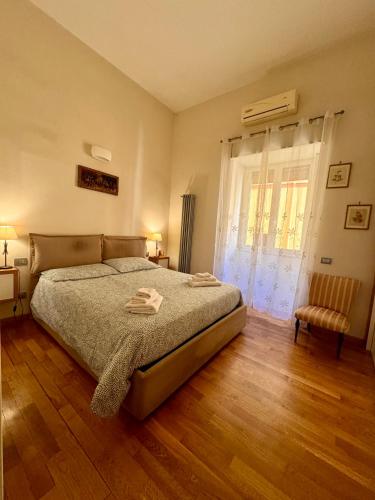 a bedroom with a bed and a window at Luisa Apartments in Naples