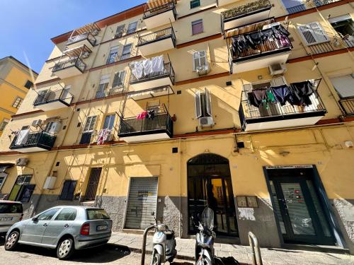 a building with a car parked in front of it at Luisa Apartments in Naples